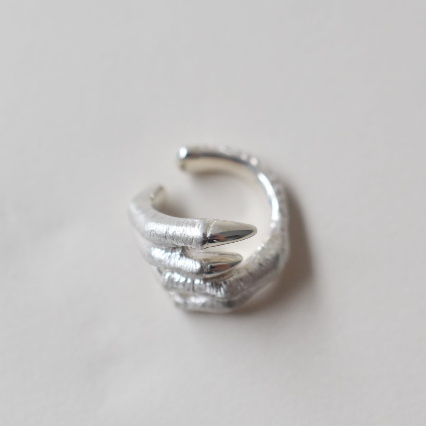 ear cuff tyrannosaurs claw cross